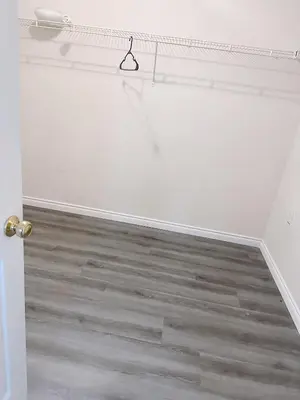 a room with a white wall and a wooden floor at Big master bedroom private bathroom in Fontana