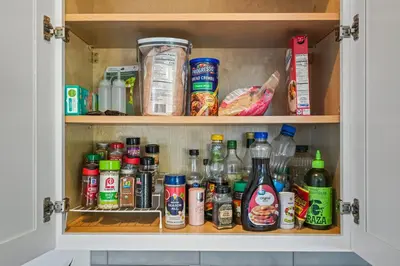 a cabinet filled with lots of food and drinks at Belmont Shore Getaway with Hot Tub and Firepit in Long Beach