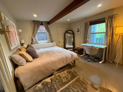 a bedroom with a bed and a desk in it at Hollywood Hills Duplex with view and parking! in Los Angeles