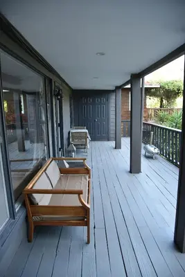 a porch with two benches on a wooden deck at Hollywood Hills Duplex with view and parking! in Los Angeles