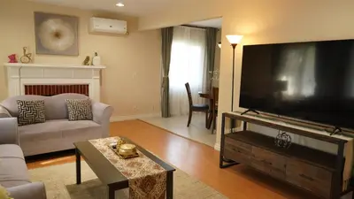 a living room with a large flat screen tv at \u6c11\u5bbf\u963f\u5c14\u7f55\u5e03\u62c9666 in Alhambra
