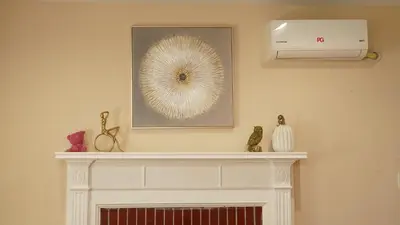 a fireplace in a living room with a picture on the wall at \u6c11\u5bbf\u963f\u5c14\u7f55\u5e03\u62c9888 in Alhambra