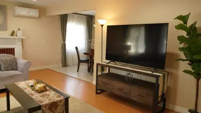 a living room with a large flat screen tv at \u6c11\u5bbf\u963f\u5c14\u7f55\u5e03\u62c9666-888 in Alhambra