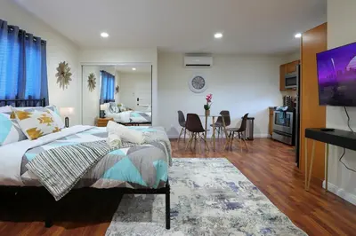 a bedroom with a bed and a living room at Modern Oasis Studio - near LAX, SoFi, USC, DTLA in Los Angeles