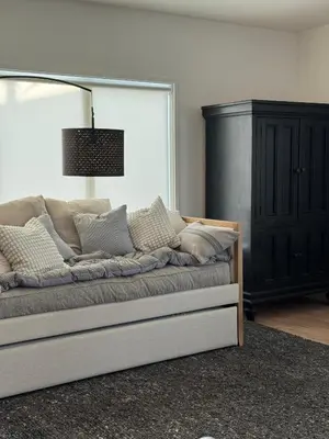 a couch with pillows on it in a living room at NEW Cozy Studio City Guesthouse in Prime Location in Studio City