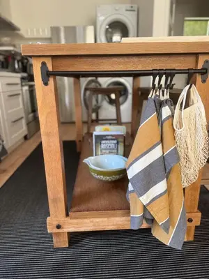 a wooden table with a bowl and utensils at NEW Cozy Studio City Guesthouse in Prime Location in Studio City