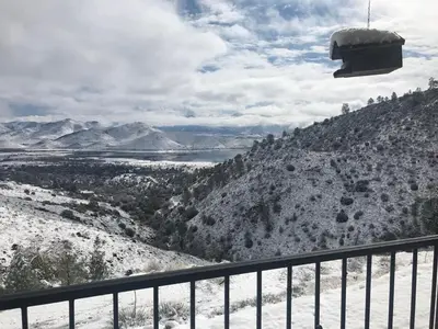 a balcony with a view of a snow covered mountain at Camp David in Wofford Heights