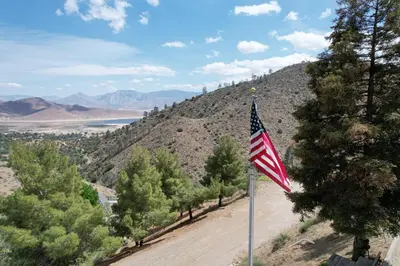 an american flag on a pole on a dirt road at Camp David in Wofford Heights