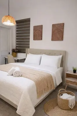 a bedroom with a large white bed and a table at 85 hotel in Eastvale