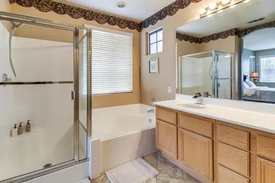 a bathroom with a shower and a tub and a sink at Pool, Patio and Games! Suburban Home in Palmdale in Palmdale