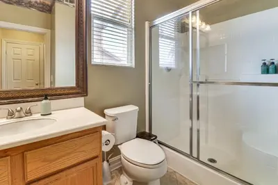 a bathroom with a toilet sink and a shower at Pool, Patio and Games! Suburban Home in Palmdale in Palmdale