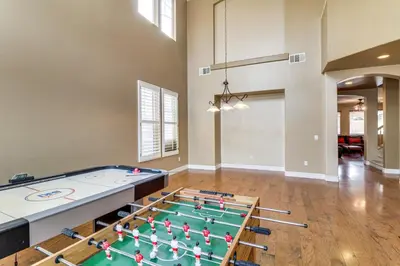 a living room with a pool table and a table at Pool, Patio and Games! Suburban Home in Palmdale in Palmdale
