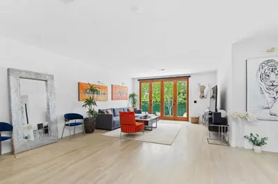 a living room with a couch and a mirror at Luxury 4BR Villa with Private Pool in Los Angeles Crescent Heights in Los Angeles