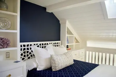 a bedroom with a bed with white pillows at Exquisite Carpinteria Beach Cottage, Steps Away From The Beach in Carpinteria