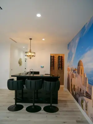 a kitchen with a black island in a room at Sleek 7BR Exquisite Estate Resort Pool, Sauna, Spa 6500 SQF in Woodland Hills