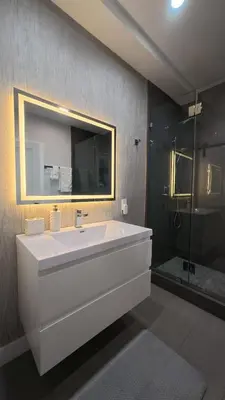 a bathroom with a large white tub and a shower at Sleek 7BR Exquisite Estate Resort Pool, Sauna, Spa 6500 SQF in Woodland Hills