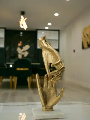 a gold figurine of a hand in a museum at Sleek 7BR Exquisite Estate Resort Pool, Sauna, Spa 6500 SQF in Woodland Hills
