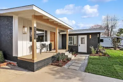 a small house with a porch with a table at Quintessential SoCal indoor outdoor living with POOL in Long Beach
