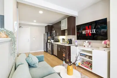 a living room with a couch and a kitchen at Sunny Santa Monica Retreat, Walk to Beach in Santa Monica