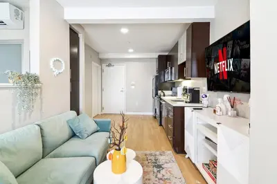 a living room with a couch and a kitchen at Sunny Santa Monica Retreat, Walk to Beach in Santa Monica