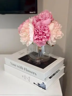 a vase with flowers sitting on top of books at Sunny Santa Monica Retreat, Walk to Beach in Santa Monica