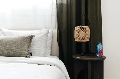 a bedroom with a bed and a table with a lamp at Pacific Aura in Los Angeles