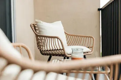a wicker chair with a white pillow sitting on a table at Pacific Aura in Los Angeles