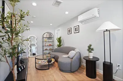 a living room with a gray chair and a table at A Fresh, Relaxing Oasis Near Monrovia Canyon Park in Duarte