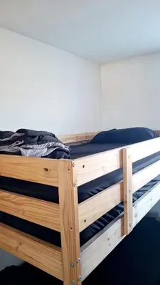 a wooden bunk bed in a room at Normandie Vibes Hostel in Los Angeles
