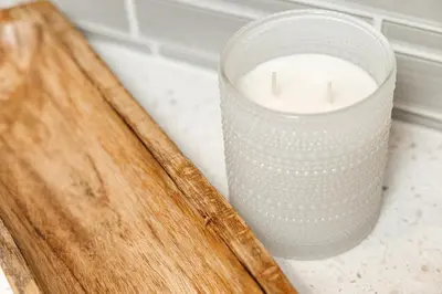 a candle on a counter next to a wooden board at West Hollywood Luxe Townhome Walkable WeHo Avalon in Los Angeles