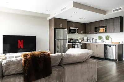 a living room with a couch and a kitchen at West Hollywood Luxe Townhome Walkable WeHo Avalon in Los Angeles