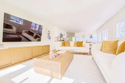 a living room with a white couch and a coffee table at Chic 6BR West Hollywood Villa with Jacuzzi in Los Angeles