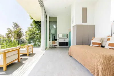a bedroom with a bed and a balcony with a television at Hillside 4B Villa w Infinity Pool City Views in Los Angeles