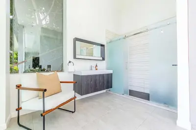 a bathroom with a sink and a mirror at Hillside 4B Villa w Infinity Pool City Views in Los Angeles
