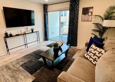 a living room with a couch and a tv at Cozy Century City 2 Br Sleeps 6 with Parking 505 in Los Angeles