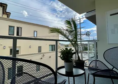 a balcony with a table and chairs and a plant at Cozy Century City 2 Br Sleeps 6 with Parking 505 in Los Angeles