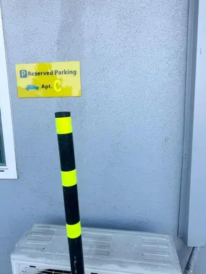 a yellow and black pole with a sign on a wall at Asian Food Gallery mini back room in San Gabriel