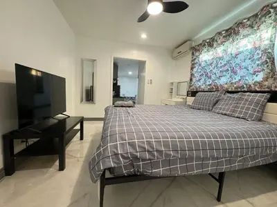 a bedroom with a bed and a desk and a television at Asian Food Gallery mini back room in San Gabriel