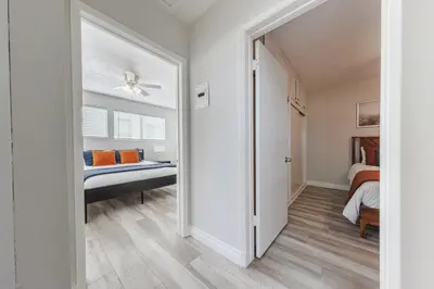 a bedroom with a bed and a door leading into a room at Spacious 2-Bedroom Duplex in Beverly Hills Residential Area in Los Angeles