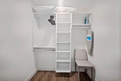 a white refrigerator with shelves and a chair at Casa Blanca Coastal Condo Rooftop Heated Pool in Los Angeles