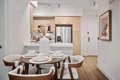 a kitchen and dining room with a table and chairs at Casa Blanca Coastal Condo Rooftop Heated Pool in Los Angeles