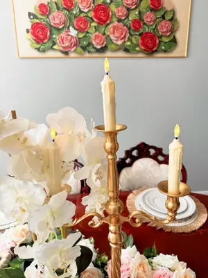 a table with three candles and a painting of roses at 3000sqft Modern Minimal 5BR3BA Home Near ONT in Ontario