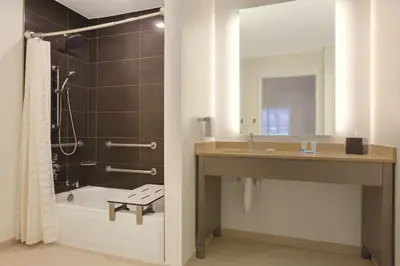 a bathroom with a sink and a tub and a shower at Hyatt House Cypress / Anaheim in Cypress