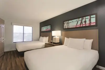 a hotel room with two beds and two windows at Hyatt House Cypress / Anaheim in Cypress