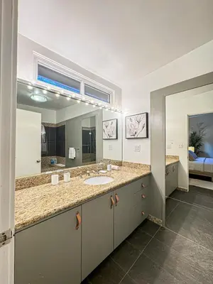 a bathroom with a sink and a large mirror at Charming 4-Bedroom Home Near Bel Air - BG - WW in Los Angeles