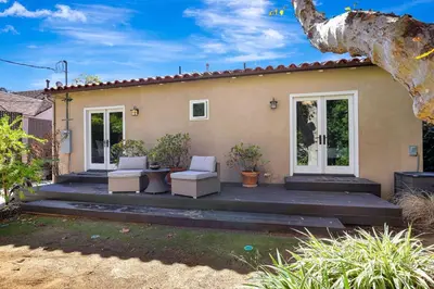 a home with a large porch with white chairs at Charming 2BR 2BA Los Angeles Home with Character in Sherman Oaks Community Hospital Heliport