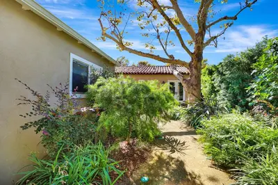a house with a tree next to a garden at Charming 2BR 2BA Los Angeles Home with Character in Sherman Oaks Community Hospital Heliport