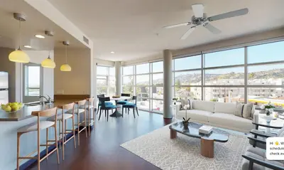 a living room with a couch and a table at Modern 2BR at the Huxley Prime West Hollywood Location in Los Angeles
