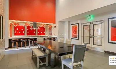 a dining room with a black table and chairs at Modern 2BR at the Huxley Prime West Hollywood Location in Los Angeles