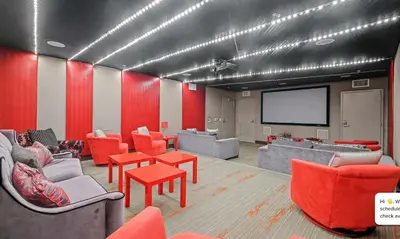 a conference room with couches and a projection screen at Modern 2BR at the Huxley Prime West Hollywood Location in Los Angeles